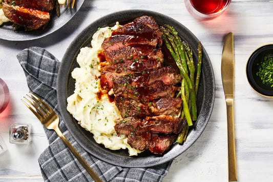 Pan-seared halal grass-fed ribeye with garlic herb butter and mashed potatoes