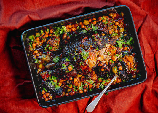 Halal lamb shoulder chops braised with dried apricots, chickpeas, and Moroccan spices