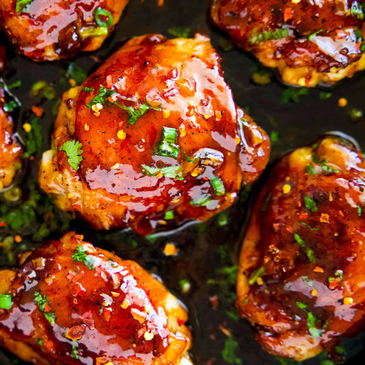 Halal boneless skinless chicken thighs seared golden in a sticky honey garlic glaze