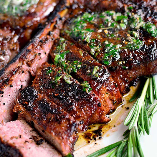 Grilled halal grass-fed ribeye with melting garlic herb compound butter