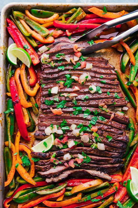 Halal grass-fed flank steak fajitas with sizzling peppers and onions