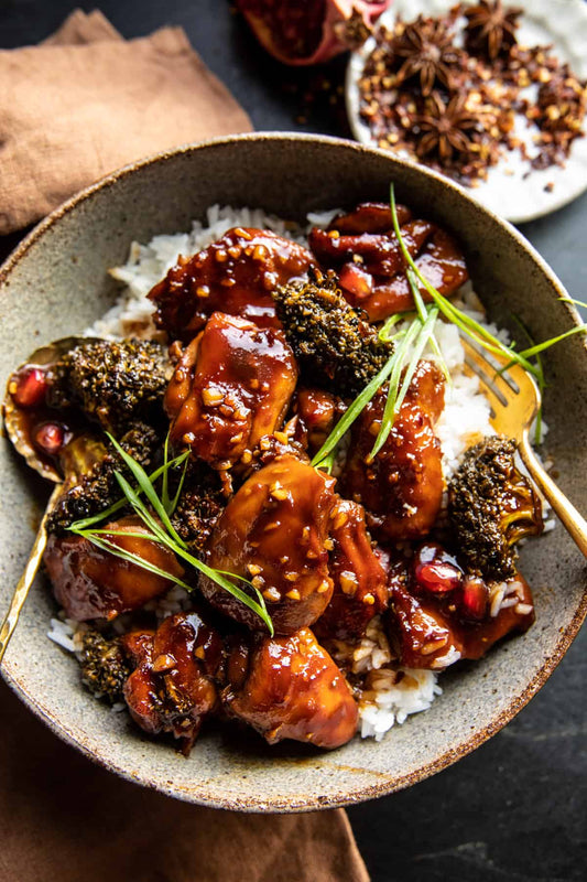 Crispy halal chicken thighs glazed with ginger soy sauce over steamed rice