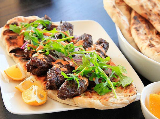 Halal free-range ground goat kofta grilled to a char with harissa yogurt